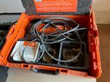 an orange tool box with tools in it on the floor