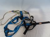 a blue leash and a blue harness on a white surface
