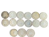 several different types of coins are arranged in a row on a white surface