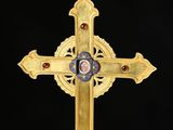 an image of a gold cross with a picture of a woman on it