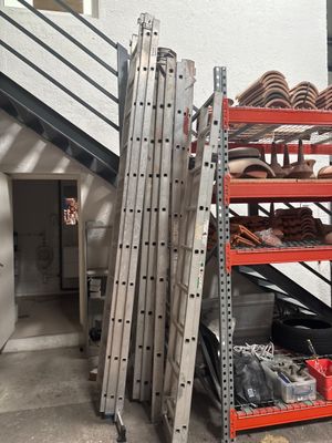 a stack of metal shelves in a garage next to a staircase
