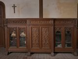 a large wooden cabinet with a cross on the top of it