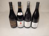 four bottles of wine are lined up on a counter