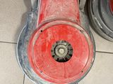 a red machine that is sitting on the floor