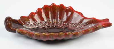 red glass bowl on white background with red and gold decoration