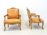 pair of french louis xv style carved wood armchairs with leather upholstered seats
