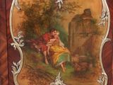 a painting of a woman and a child on a cabinet