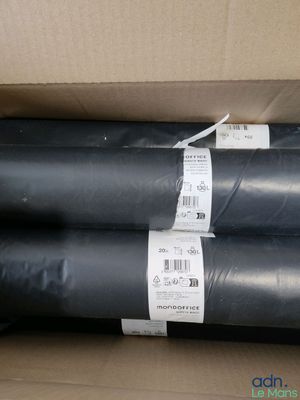 several rolls of black plastic sitting in a box on top of a cardboard box