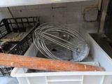 a whisk in a white container with a wooden handle