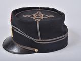 a black hat with a gold emblem on it