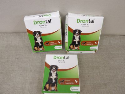 three boxes of drontal for dogs sitting on a couch