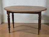 a small table with a wooden top on a hard wood floor