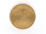 a gold coin on a white surface with a white background