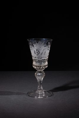 a glass that is on a table with a black background