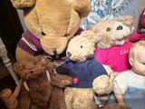 a lot of stuffed animals that are sitting on a chair