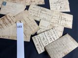 several pieces of old paper with writing on them sitting on a table