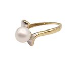 a close up of a pearl ring on a white background