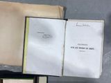 several open books sitting on top of each other on a table