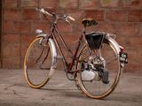 a bike that is parked in front of a brick wall