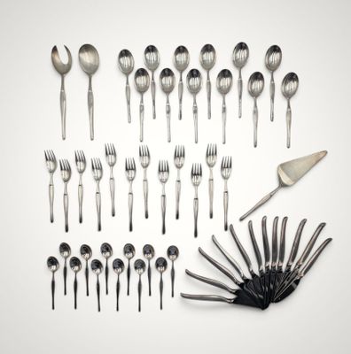 many forks and spoons laid out on a white surface