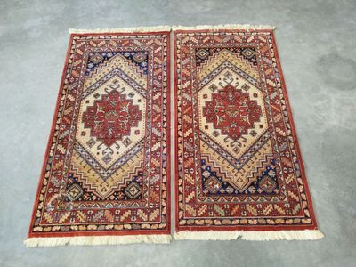 a pair of antique persian rugs
