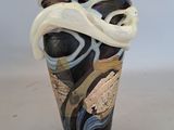 a vase with a black and white design on it