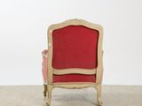 an image of a red chair sitting on top of a carpeted floor
