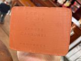 someone is holding a piece of red clay in their hand