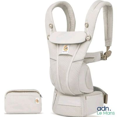 the baby carrier is white and has a pouch on the back