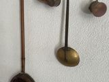 a wall with a bunch of pots and pans hanging on it