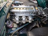 a car engine in the trunk of a green car