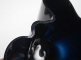 a close up of a person holding a black vase