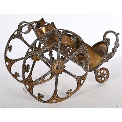 an antique brass carriage with wheels and wheels on a white background