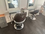 a picture of a hair salon with chairs and a mirror