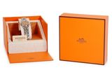 an orange box with a watch inside of it on a white surface