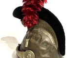 a helmet with a red feather on top of it
