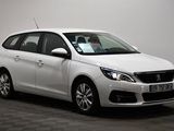 the small white car is parked in a room with a checkered floor