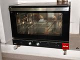 a black oven sitting on a counter in a kitchen