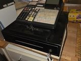 an image of a cash register on a counter in a store