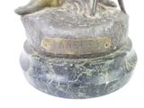 a statue of a woman sitting on top of a marble base