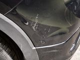 a close up of a car ' s front bumper with scratches on it
