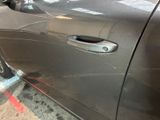 a close up of a car door handle on the side of the road