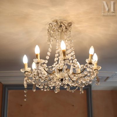 a chandelier with three lights hanging from it ' s ceiling