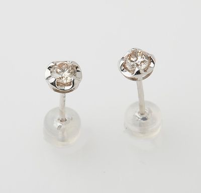 a pair of diamond stud earrings