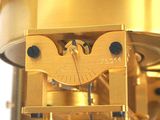 a golden clock that is sitting on a stand