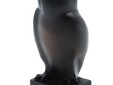 an image of a black owl statue sitting on top of a black base