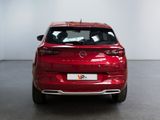 the rear end of a red car in a white room