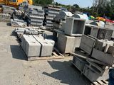 a man that is standing next to a pile of concrete blocks