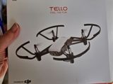 a person holding a box with a remote control drone in it