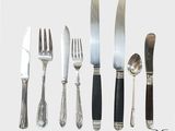 cinq types différents de couteaux et de cuillères sur la table